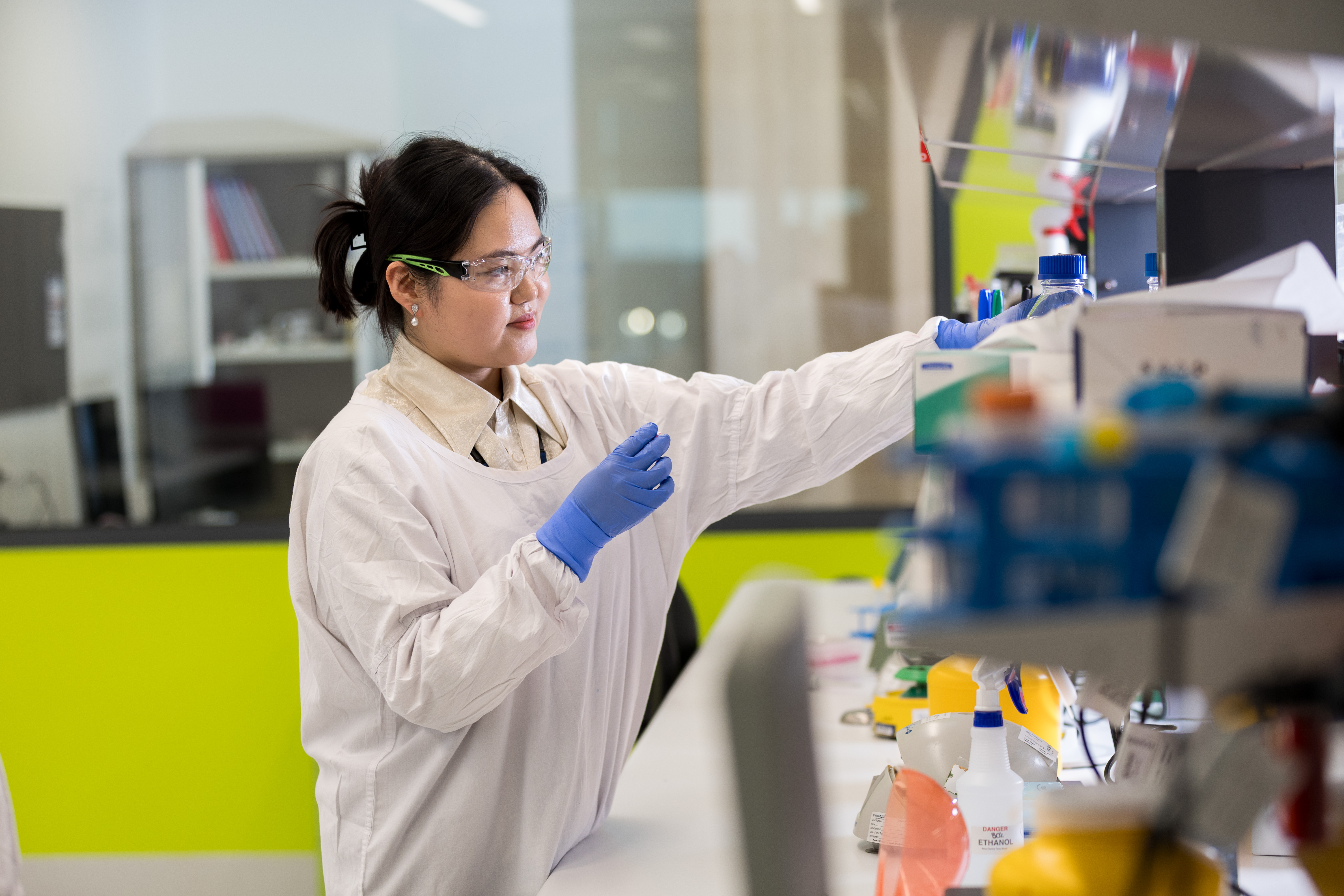 Woman reaching for supply in lab