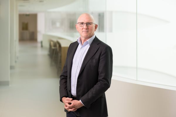 Man standing in front of glass wall