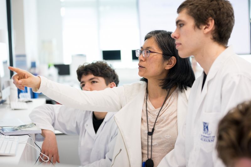 Teacher pointing to screen with students paying attention