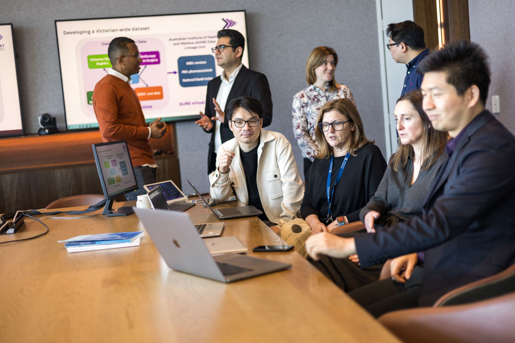 Group working around table together in office