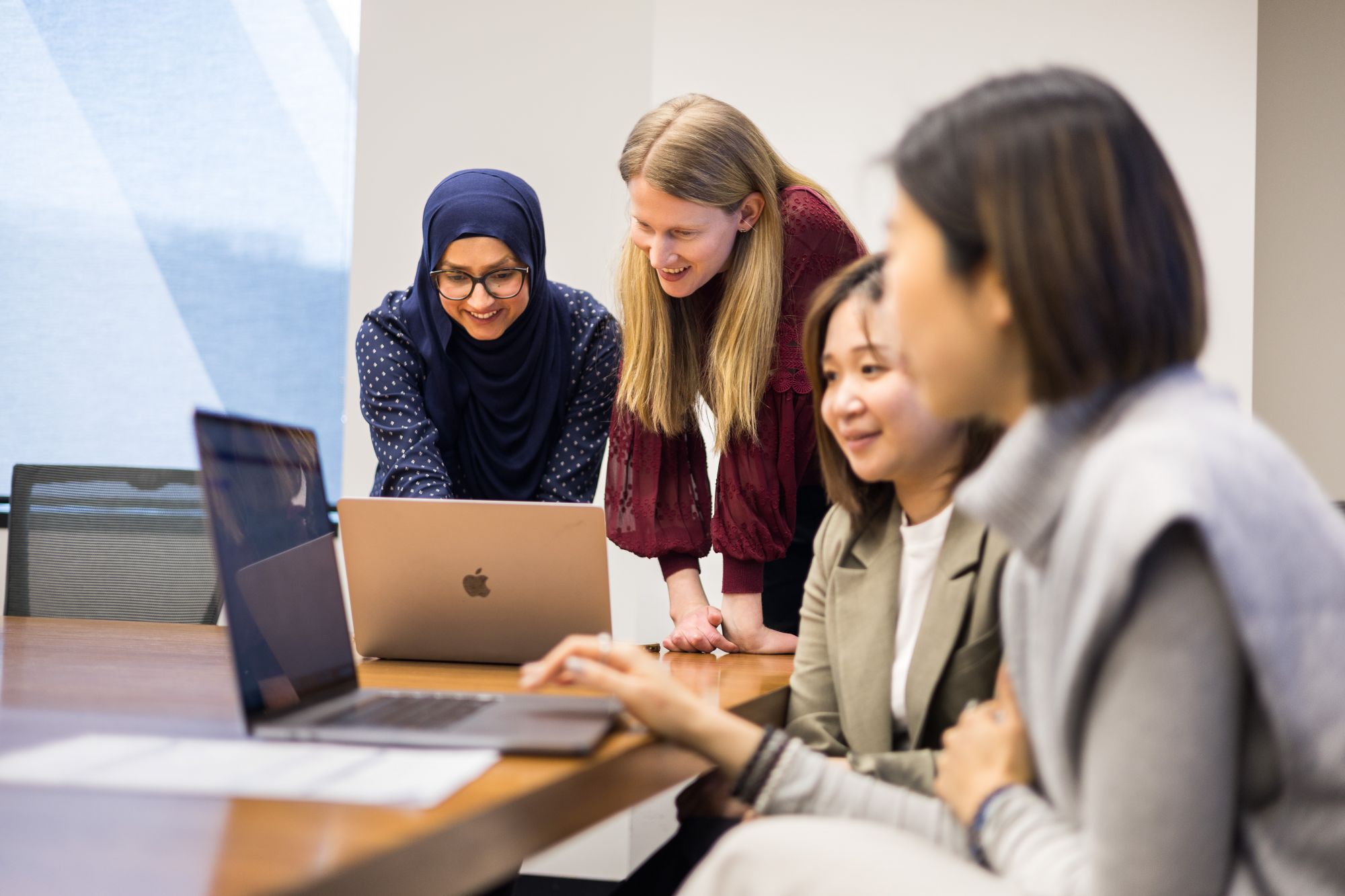 Two women looking at computer screen together