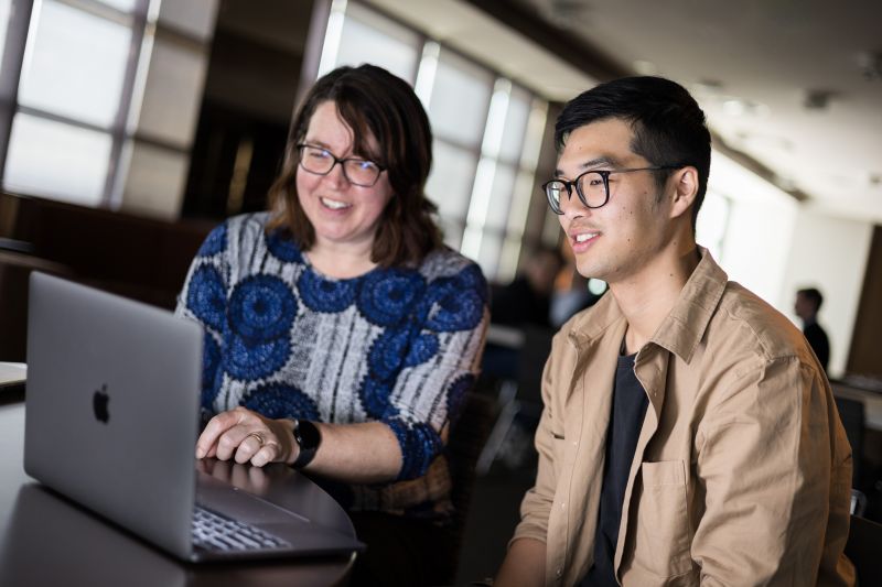 Two people looking at computer screen