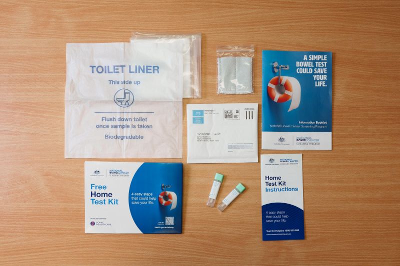 Bowel cancer screening test kit contents laid out on table